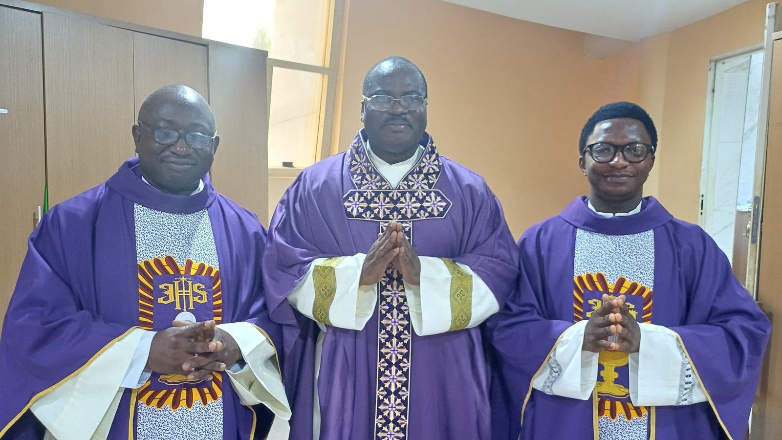 Padre Mike with two brother priests in violet vestments