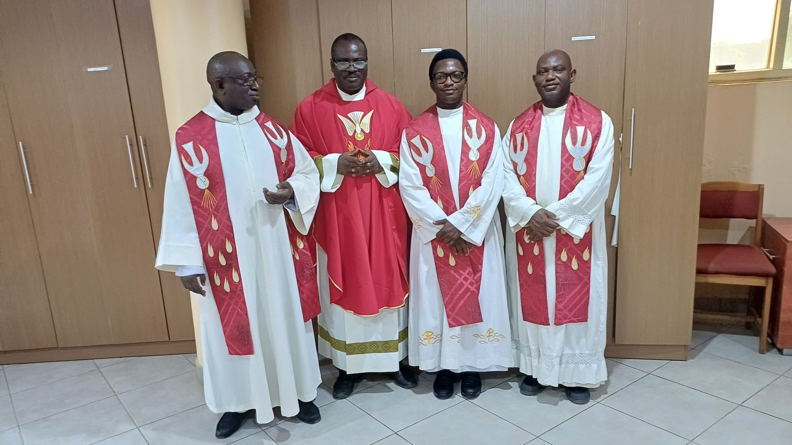 Padre Mike with three brother priests in red vestments